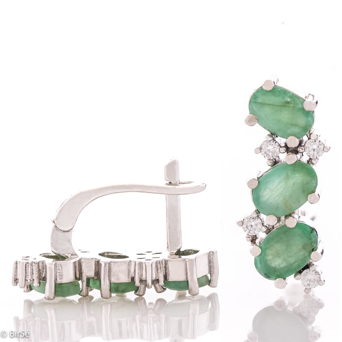 Delicately radiant English clasp earrings for women, finely crafted entirely in beautiful rhodium-plated sterling silver, complemented by exquisite natural emerald and sparkling zircons. Part of an elegant pendant and ring set.