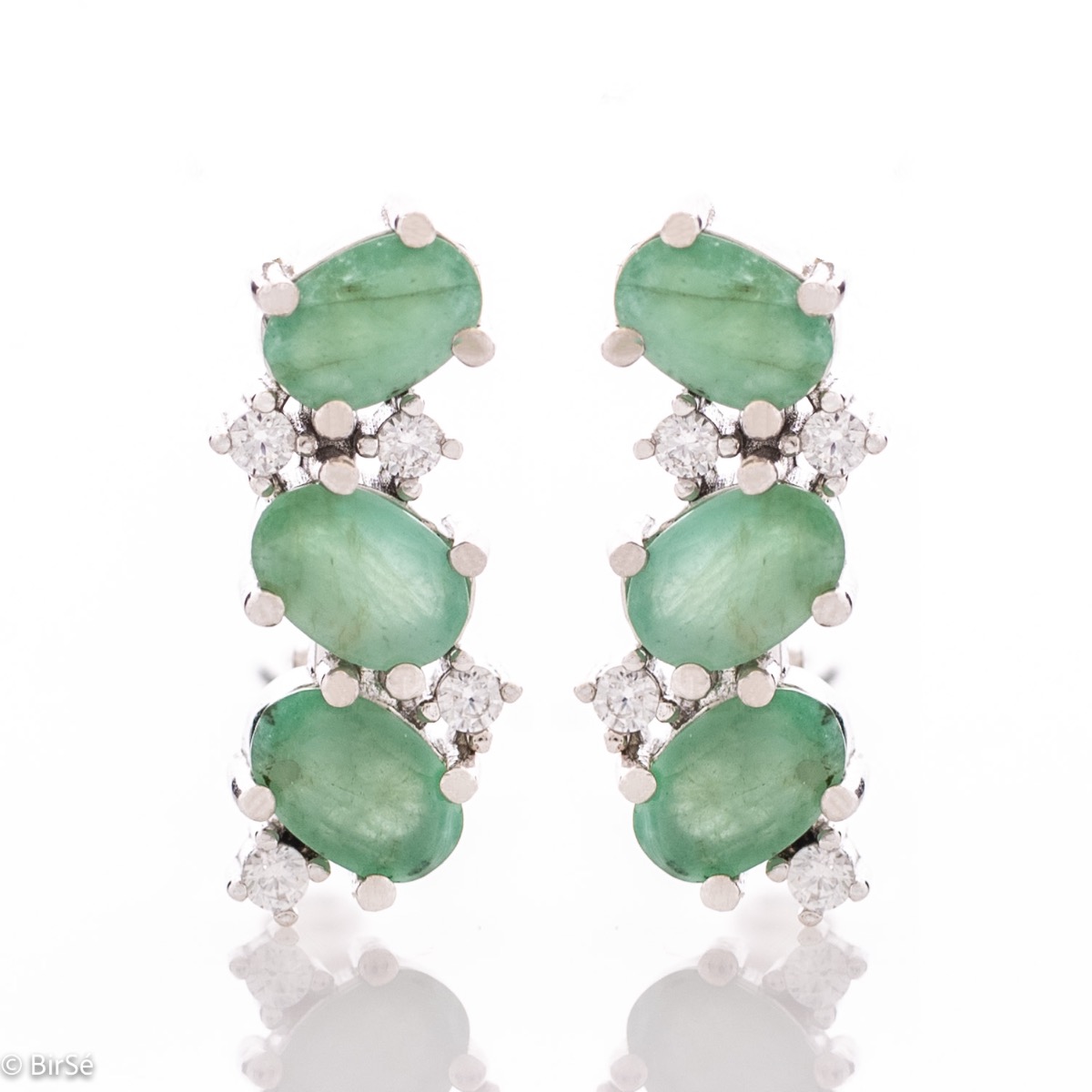 Delicately radiant English clasp earrings for women, finely crafted entirely in beautiful rhodium-plated sterling silver, complemented by exquisite natural emerald and sparkling zircons. Part of an elegant pendant and ring set.