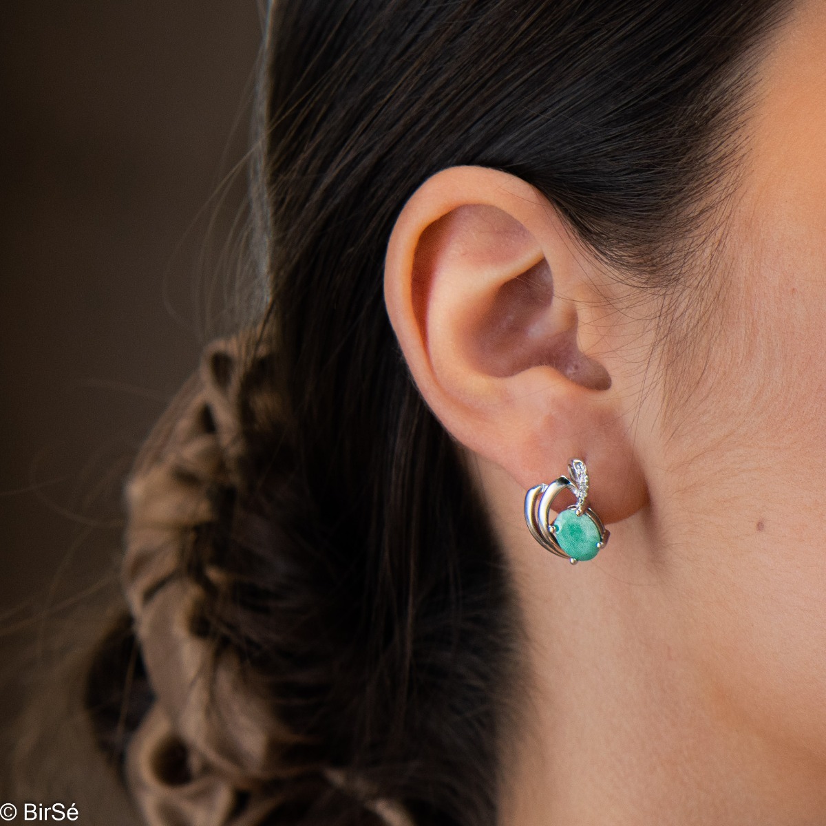 A lustrous natural emerald stone interlaced with delicate sparkling zircons and exquisitely crafted with precision to detail entirely in beautiful rhodium silver - our new ladies English clasp earrings. In an exclusive pendant and ring set.