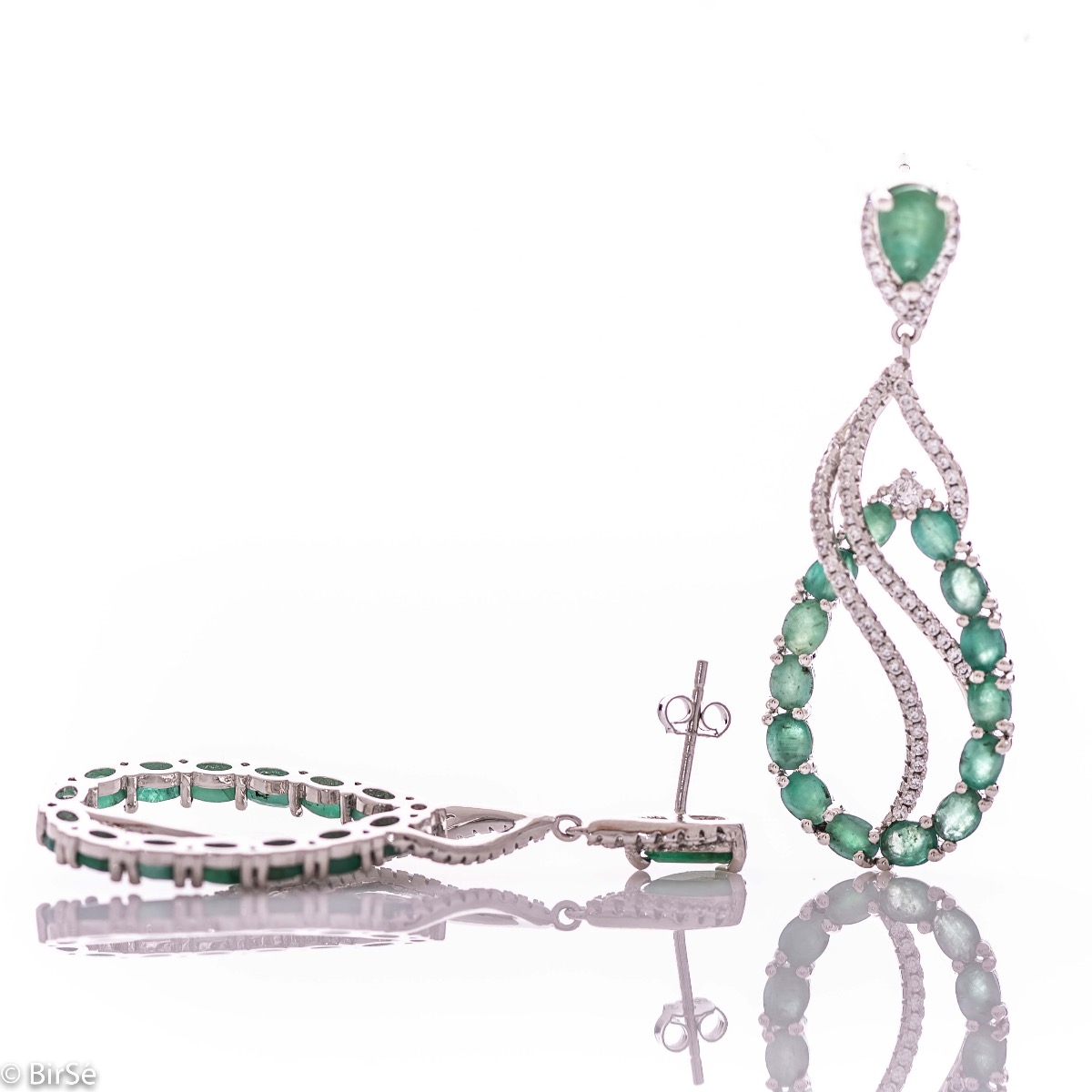 Dangling women's earrings with exceptional craftsmanship combining delicate rhodium silver with numerous and radiant natural stones emerald and zircons.