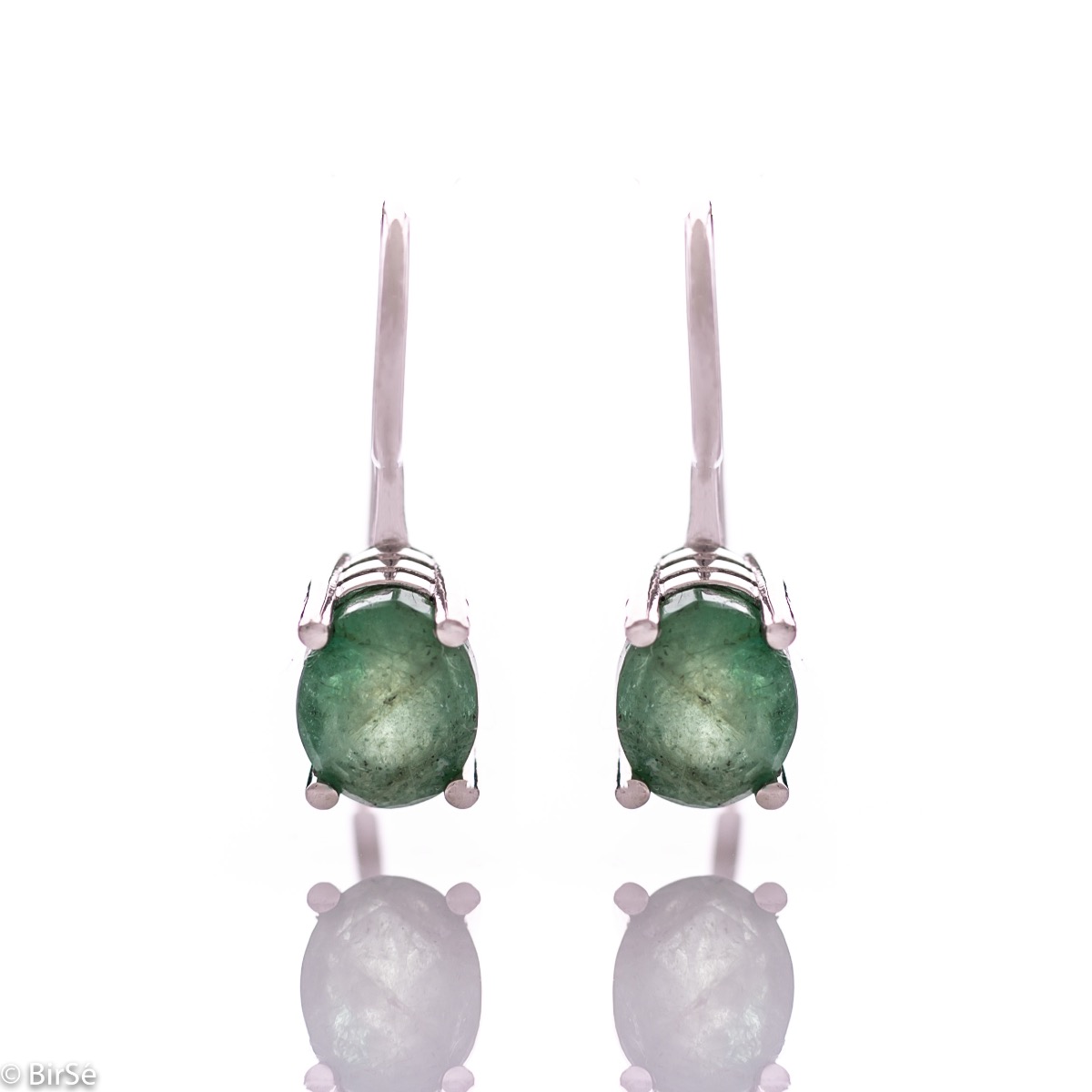 Delicate women's earrings with a clean and precise design combining shiny rhodium silver with a radiant natural emerald.