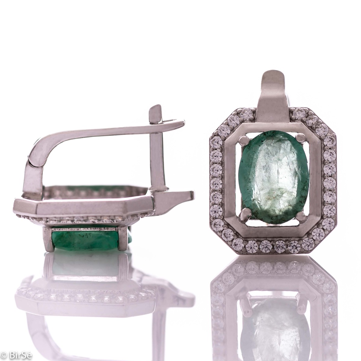 Elegant women's earrings with English clasp and precision craftsmanship entirely of rhodium-plated silver, combined with a radiant natural emerald and sparkling zircons. They can be combined with a ring and pendant of the same model.