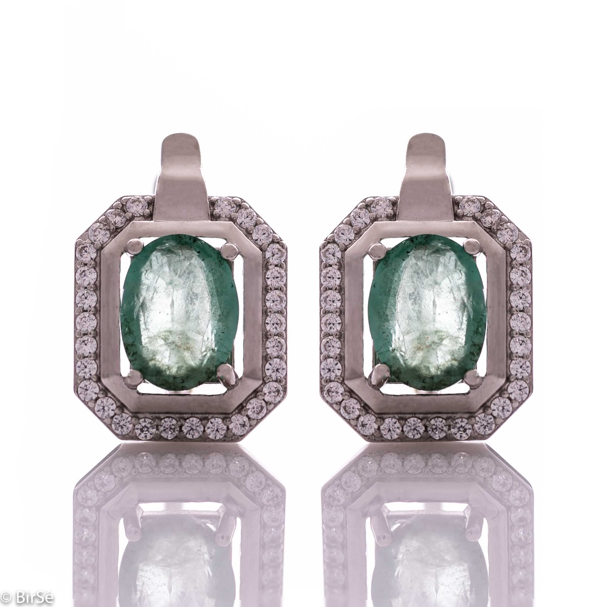 Elegant women's earrings with English clasp and precision craftsmanship entirely of rhodium-plated silver, combined with a radiant natural emerald and sparkling zircons. They can be combined with a ring and pendant of the same model.