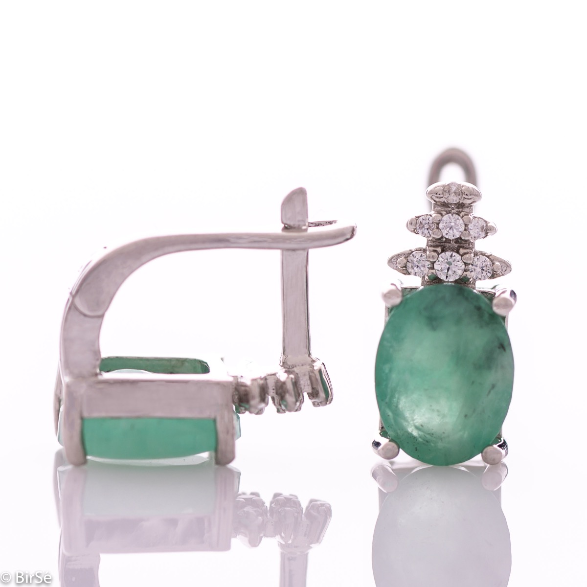 Exquisite ladies' earrings with English clasp and delicate craftsmanship entirely in rhodium-plated silver, combined with a radiant natural emerald and sparkling zircons. They can be combined with a ring and pendant of the same model.