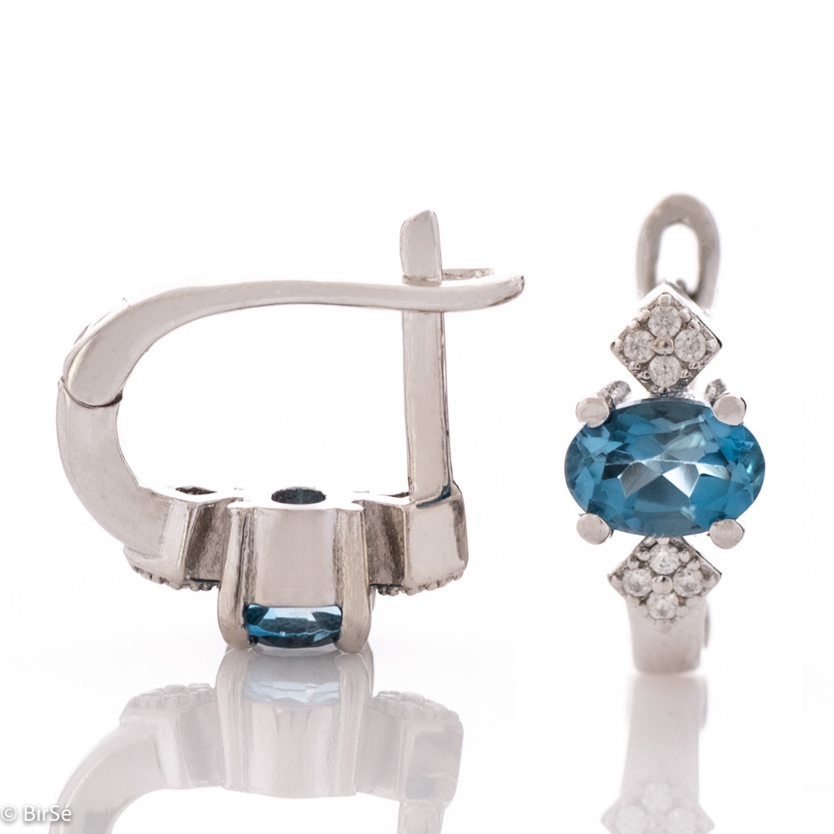 Exclusive women's earrings with unique craftsmanship and a gentle combination of a natural and radiant London topaz stone with glittering zircons and exquisite rhodium-plated silver.