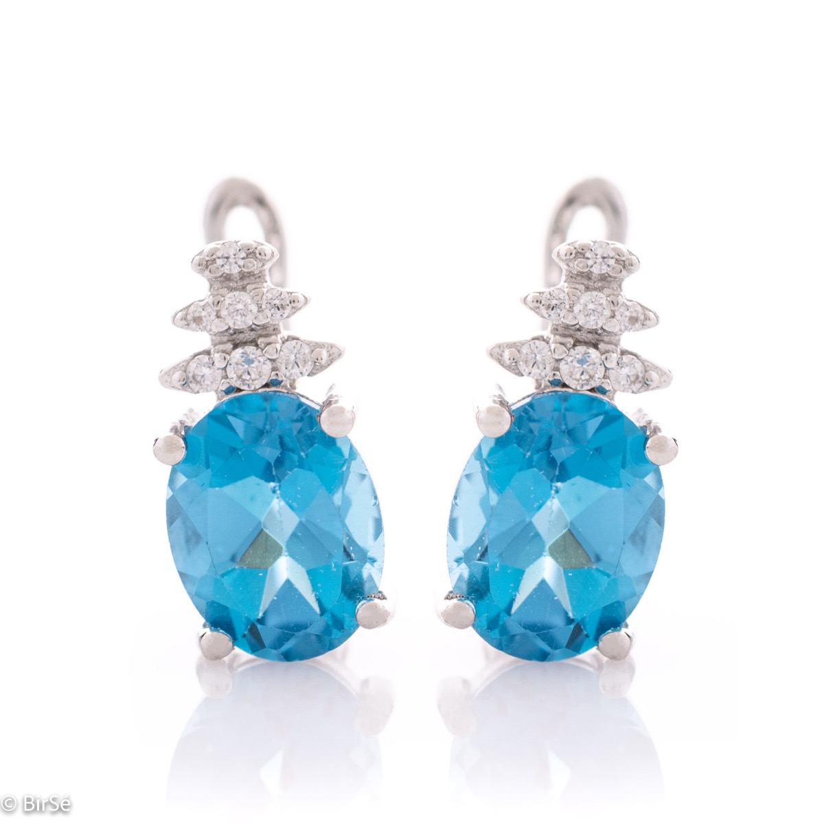 Spectacular ladies' earrings with English clasp and delicate interweaving of radiant natural London topaz with glittering rhodium silver and fine zircons.