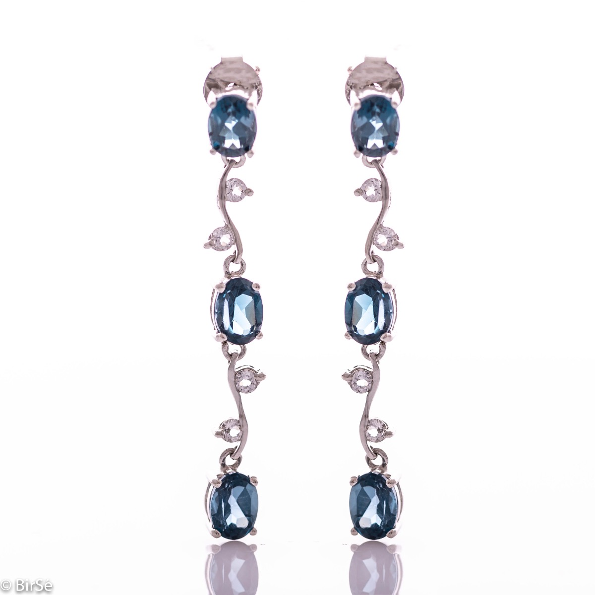 Extremely impressive dangling earrings with delicate workmanship combining numerous natural stones London topaz with shiny rhodium silver.