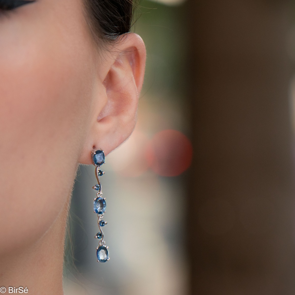 Extremely impressive dangling earrings with delicate workmanship combining numerous natural stones London topaz with shiny rhodium silver.