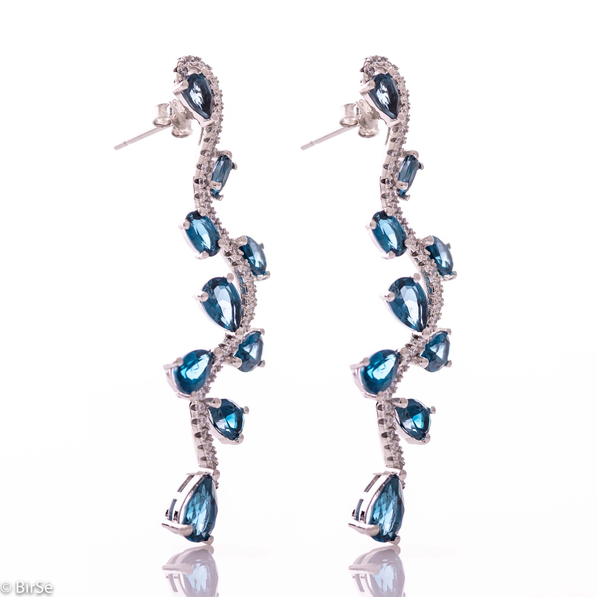 Dangling women's stud earrings with exquisite craftsmanship combining soft rhodium silver with numerous natural stones London topaz and sparkling zircons.