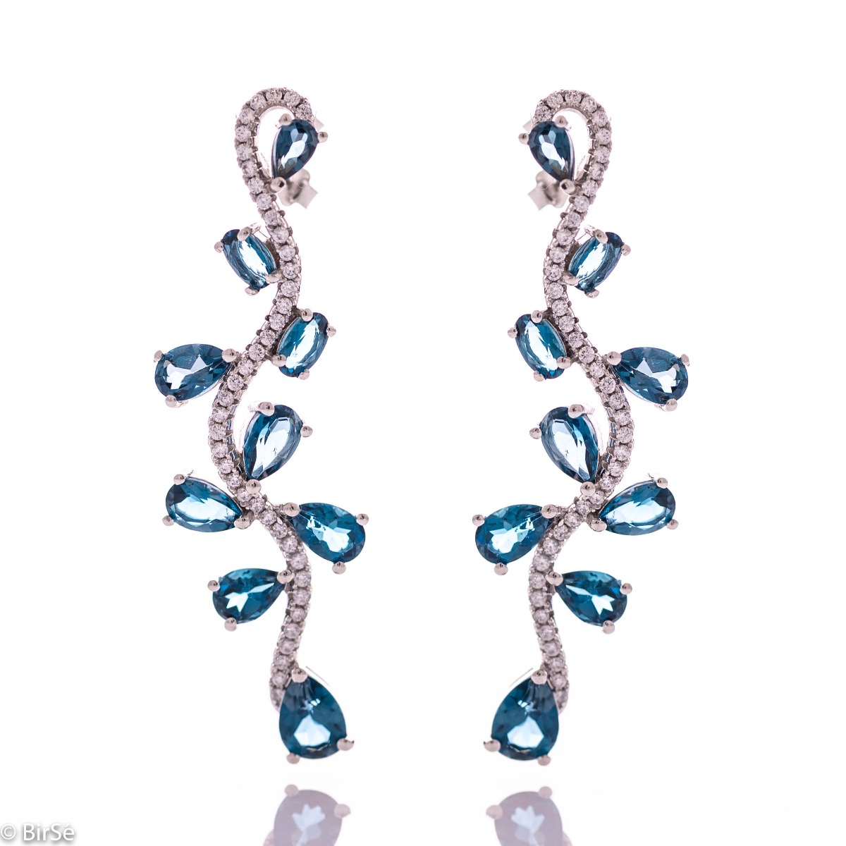 Dangling women's stud earrings with exquisite craftsmanship combining soft rhodium silver with numerous natural stones London topaz and sparkling zircons.