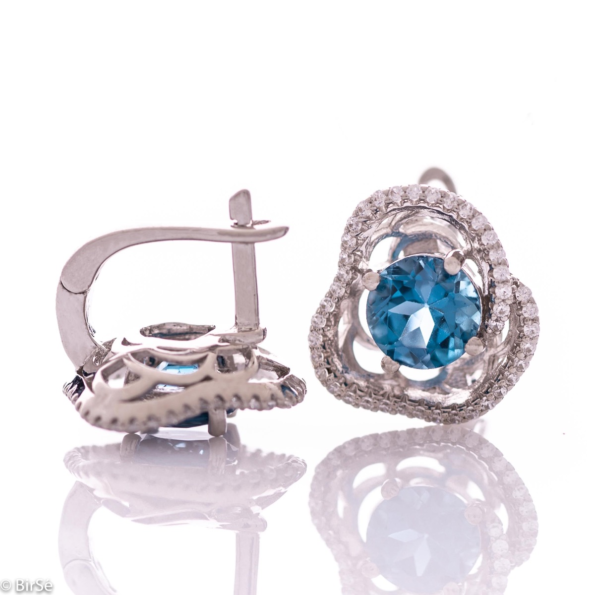 Elegant women's earrings with English clasp and exquisite workmanship entirely in rhodium-plated silver complemented by the glow of natural London topaz and sparkling zircons. They can be combined with a ring and pendant of the same model.