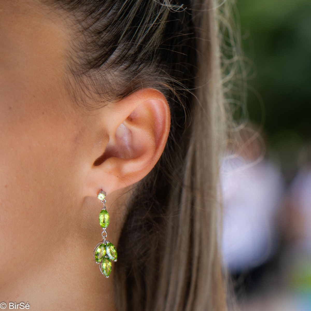 Beautiful rhodium-plated sterling silver and soft green peridot earrings. Charming jewelry for ladies with lovely green eyes.