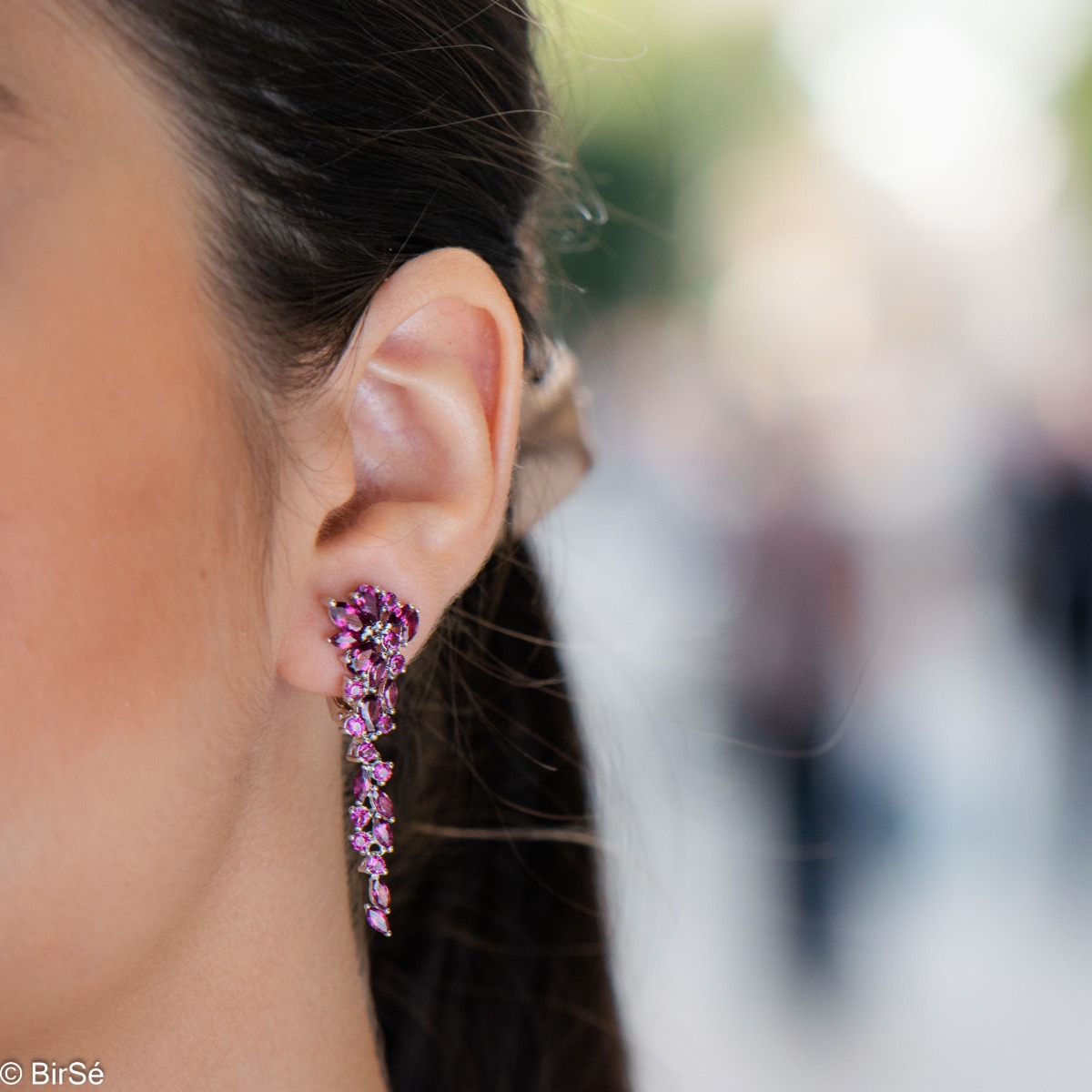 In these royally elegant rhodium silver earrings, captivating rhodolite stones gently intertwine with silver.