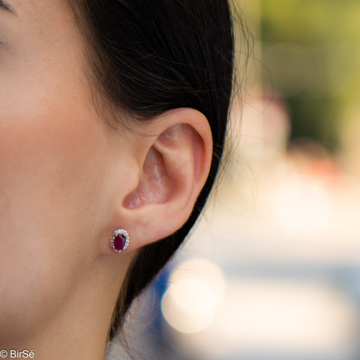 Royal perfection - stunning silver earrings with a spectacular look and pin fastening. An elegant composition made of a fine combination of rhodium-plated silver with a royal ruby ​​and dazzling zircons.