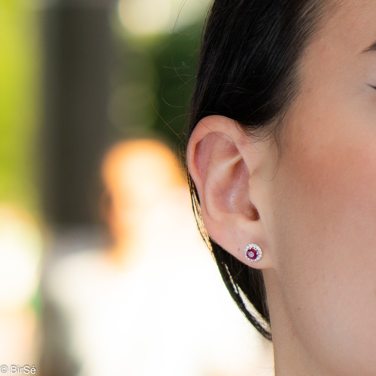 Royal beauty in stunning sterling silver earrings with delicate look and pin fastening. An elegant composition made of a fine combination of rhodium-plated silver with an exquisite ruby ​​and dazzling zircons.