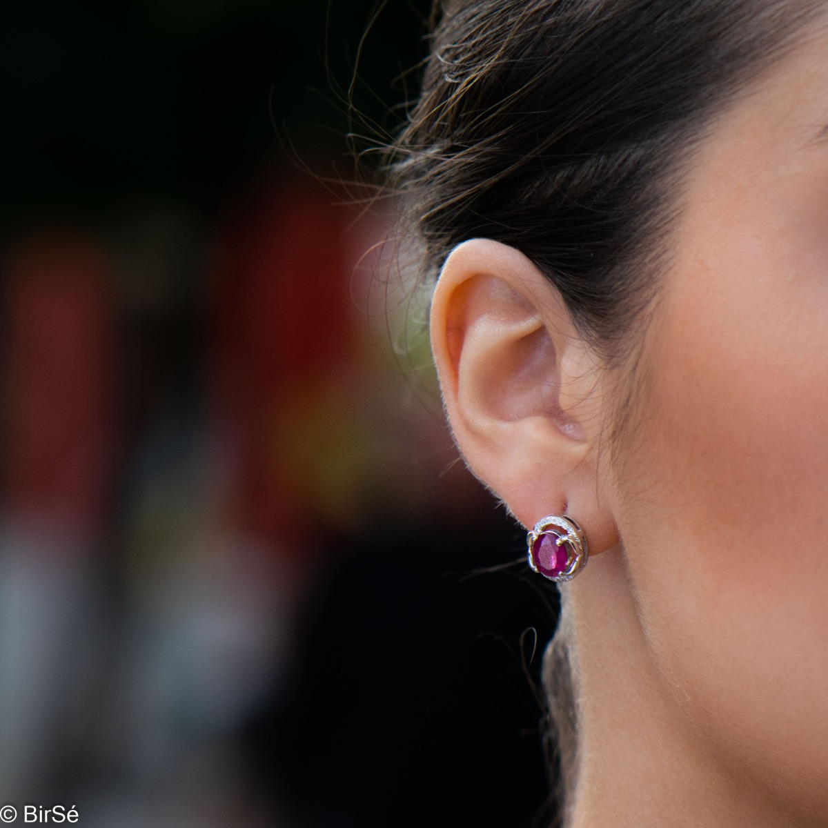 A royal vision - elegant silver earrings with a delicate design. Stylish composition made of a fine combination of rhodium-plated silver with sparkling zircon stones and an exquisite ruby. In a lovely set with a ring from the model.