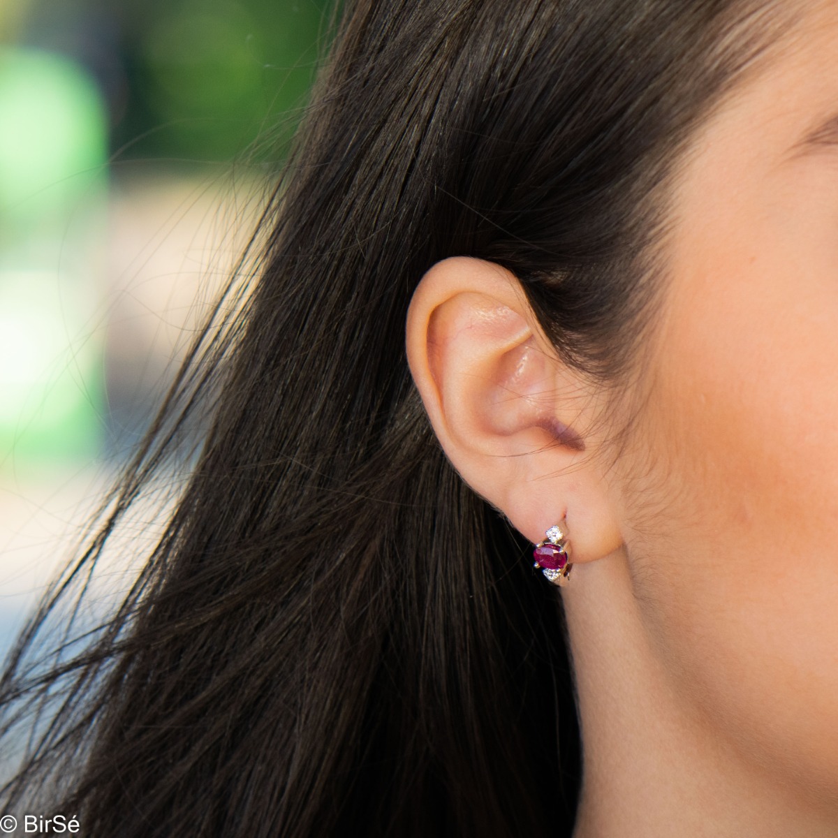 Exclusive women's earrings with English clasp and an exquisite combination of radiant natural ruby ​​with soft rhodium silver and sparkling zircons.