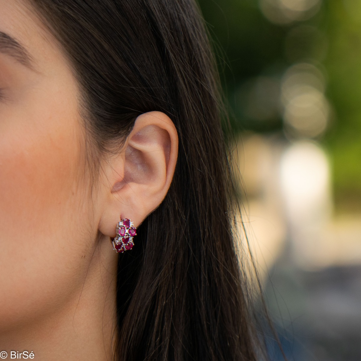 Enchanting pink glow of numerous and fine natural rubies in our new ladies English clasp earrings crafted entirely in rhodium silver and cubic zirconia. In a captivating set with a delicate necklace and ring.