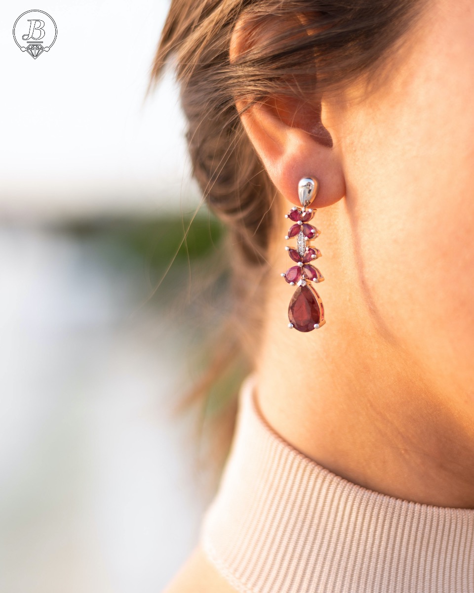 Exquisite silver earrings with precise craftsmanship combining rhodium-plated silver with delicate flowers of natural ruby ​​stone.