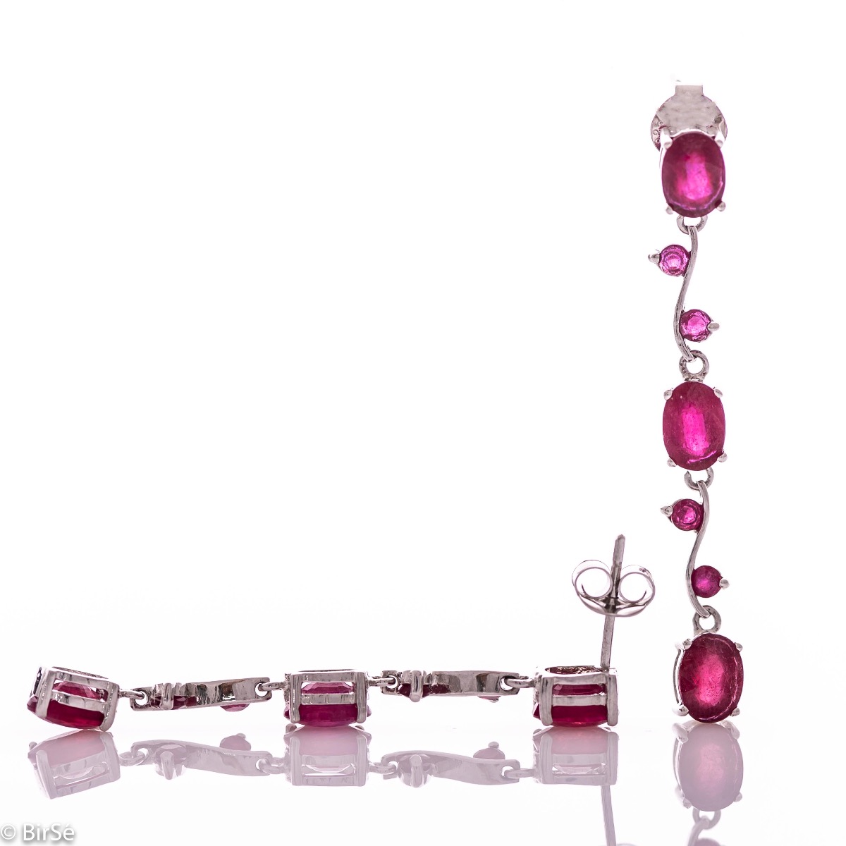 Extremely impressive dangling earrings with delicate craftsmanship combining numerous natural ruby ​​stones with shiny rhodium silver.