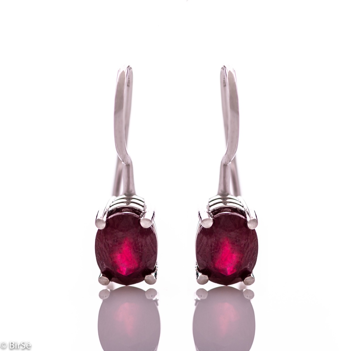 Delicate women's earrings with a clean and precise design combining shiny rhodium silver with a radiant natural ruby.