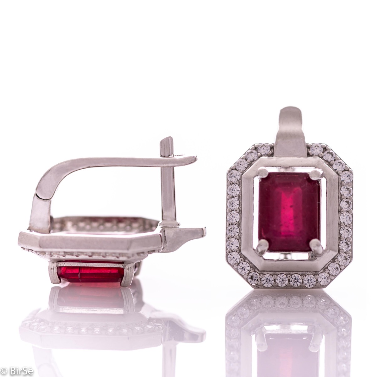 Elegant women's earrings with English clasp and precision craftsmanship entirely of rhodium-plated silver, combined with a radiant natural ruby ​​and sparkling zircons. They can be combined with a ring and pendant of the same model.