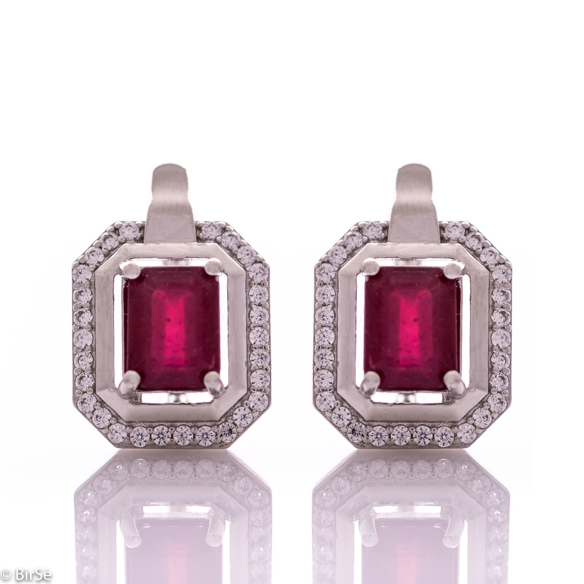 Elegant women's earrings with English clasp and precision craftsmanship entirely of rhodium-plated silver, combined with a radiant natural ruby ​​and sparkling zircons. They can be combined with a ring and pendant of the same model.