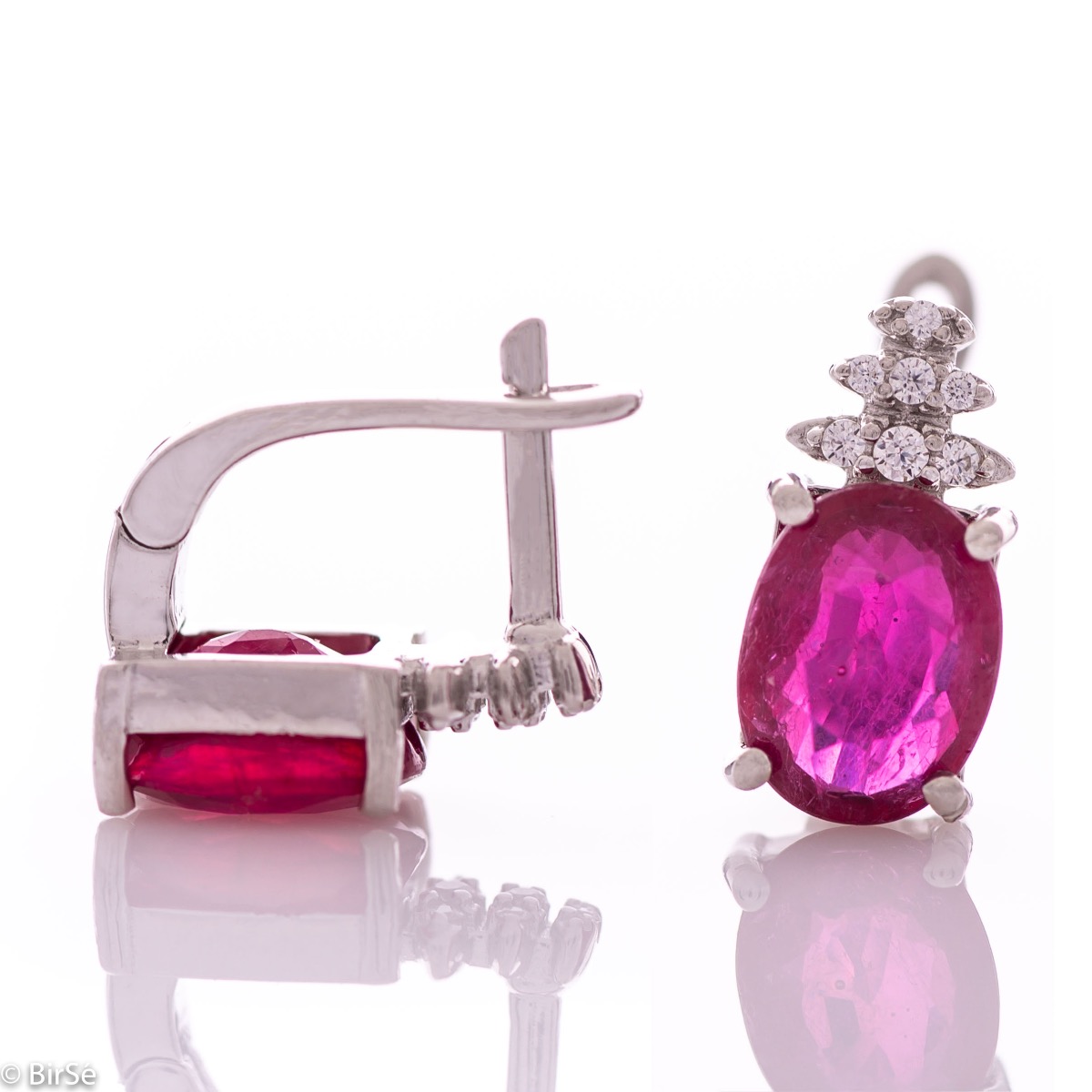 Exquisite ladies' earrings with English clasp and delicate craftsmanship entirely of rhodium-plated silver, combined with a radiant natural ruby ​​and sparkling zircons. They can be combined with a ring and pendant of the same model.