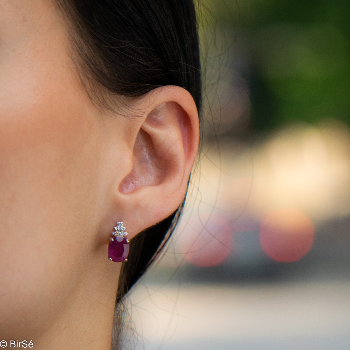 Exquisite ladies' earrings with English clasp and delicate craftsmanship entirely of rhodium-plated silver, combined with a radiant natural ruby ​​and sparkling zircons. They can be combined with a ring and pendant of the same model.