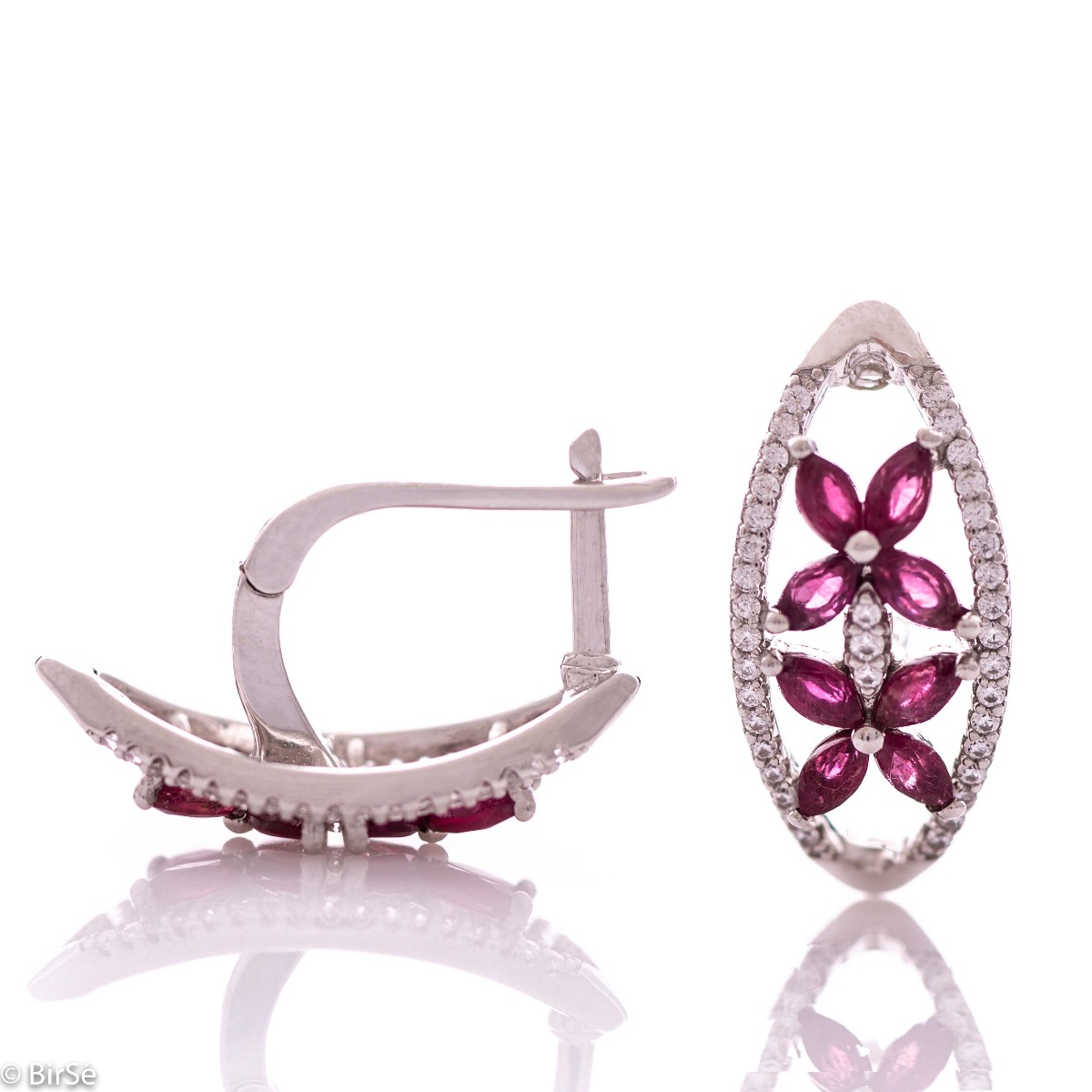 Spectacular women's earrings with exquisite workmanship entirely of rhodium-plated silver, combined with delicate flowers of natural ruby ​​and sparkling zircons. They can be combined with a ring and pendant of the same model.