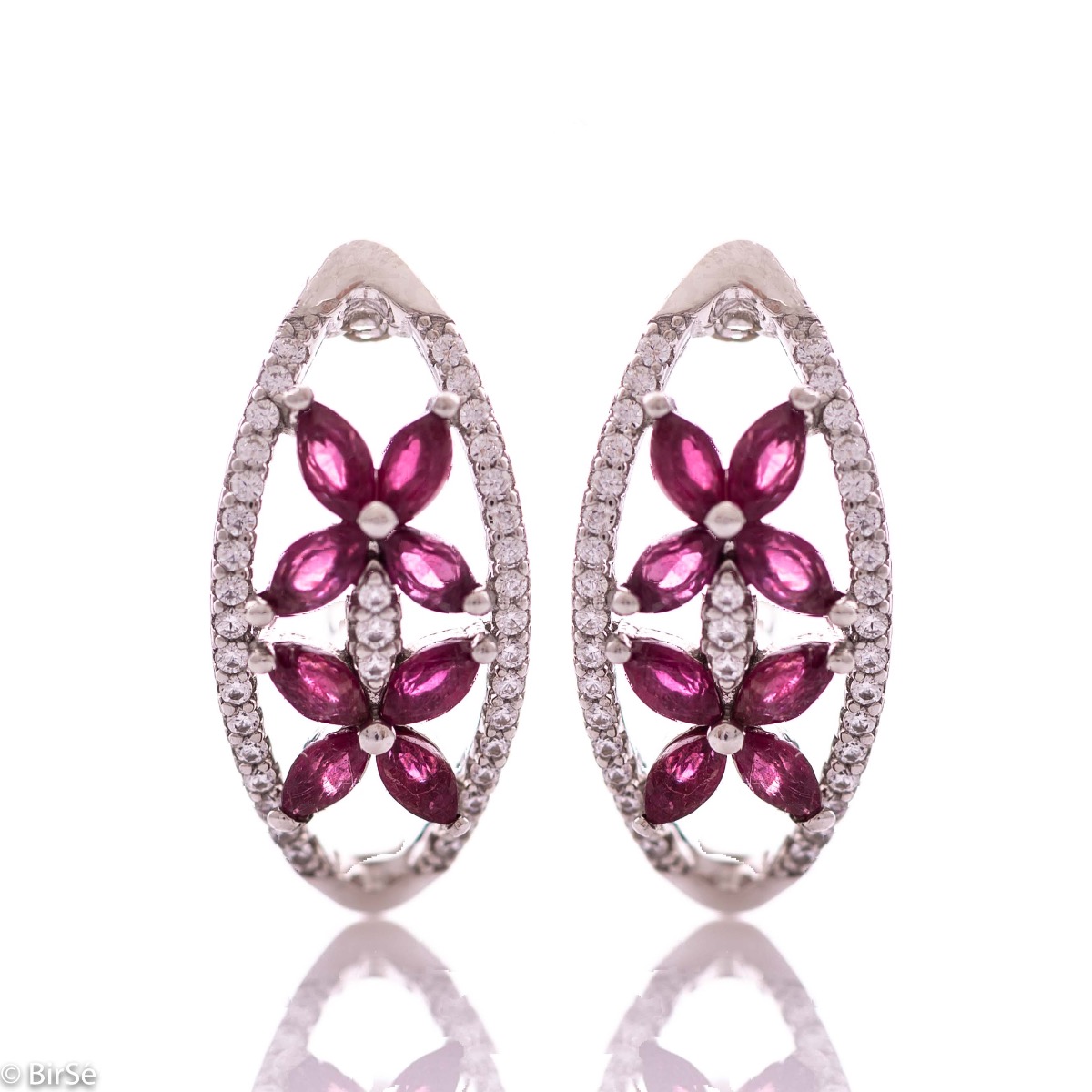 Spectacular women's earrings with exquisite workmanship entirely of rhodium-plated silver, combined with delicate flowers of natural ruby ​​and sparkling zircons. They can be combined with a ring and pendant of the same model.