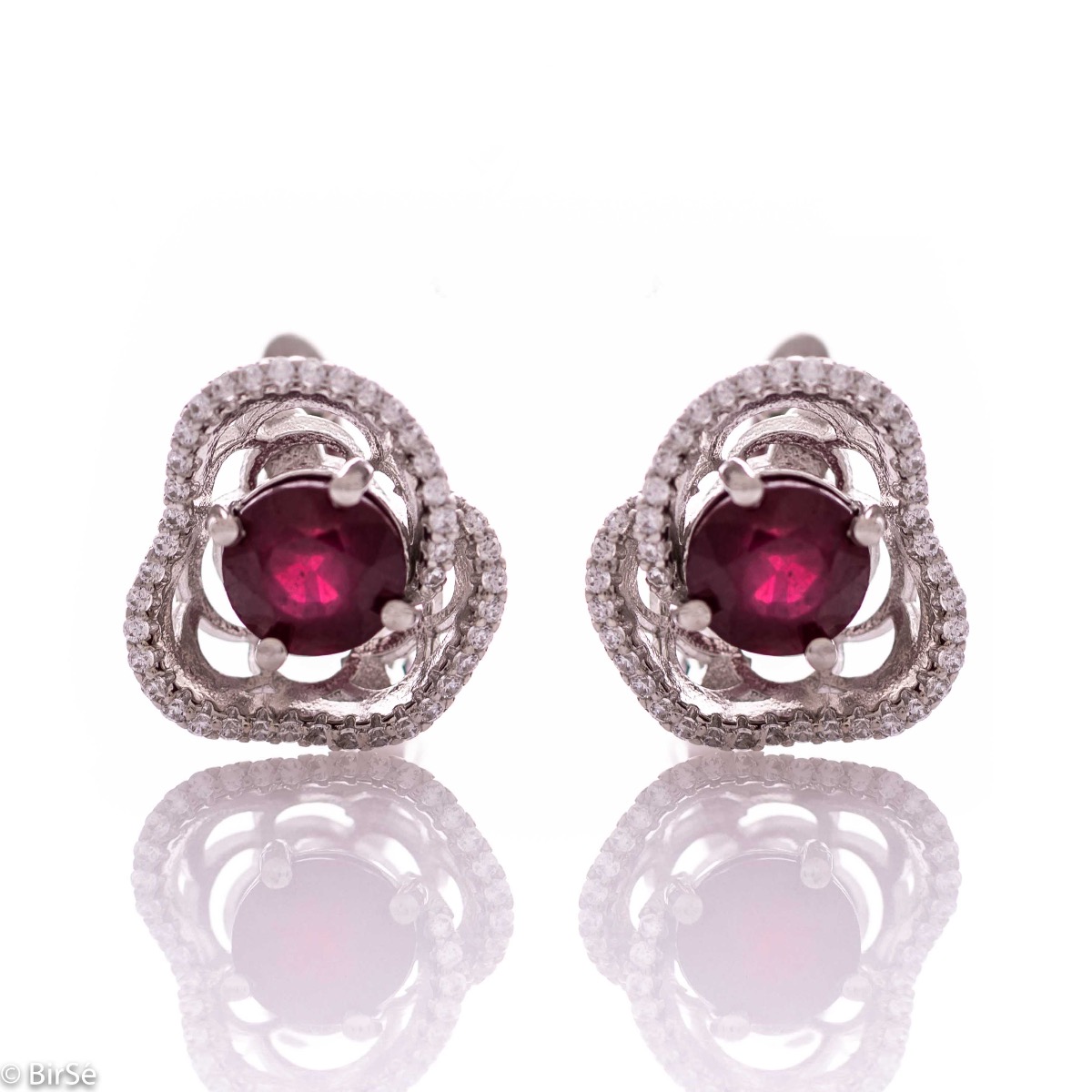 Elegant women's earrings with English clasp and exquisite workmanship entirely of rhodium-plated silver complemented by the glow of natural ruby ​​and sparkling zircons. They can be combined with a ring and pendant of the same model.