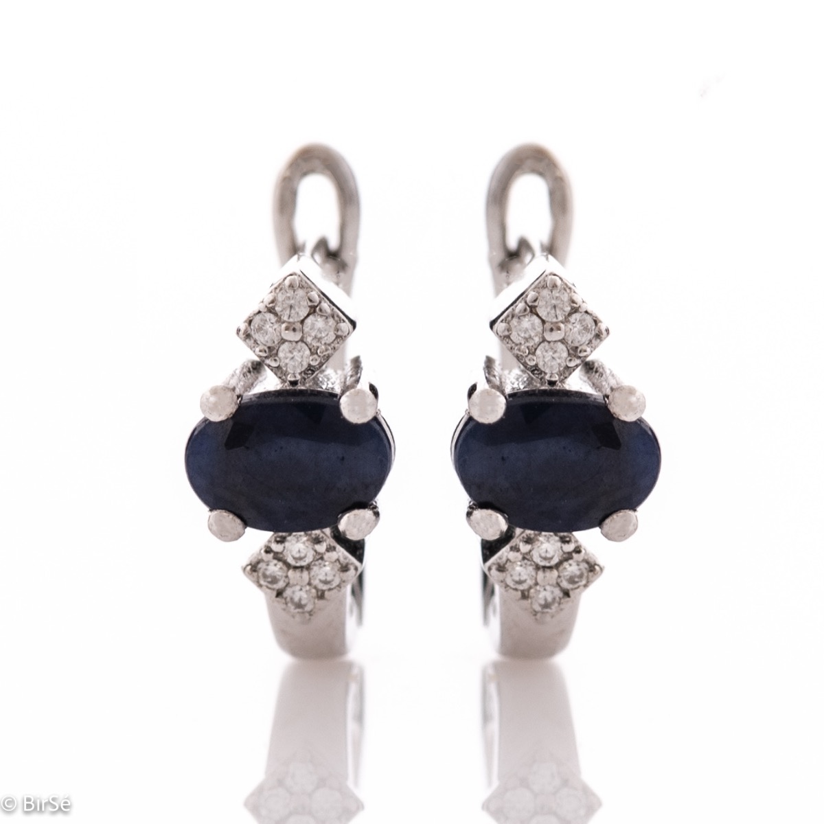 Elegant women's earrings with an English clasp and an exclusive design, combining a scorching natural sapphire stone with a sparkling zircon and made entirely of delicate rhodium silver.