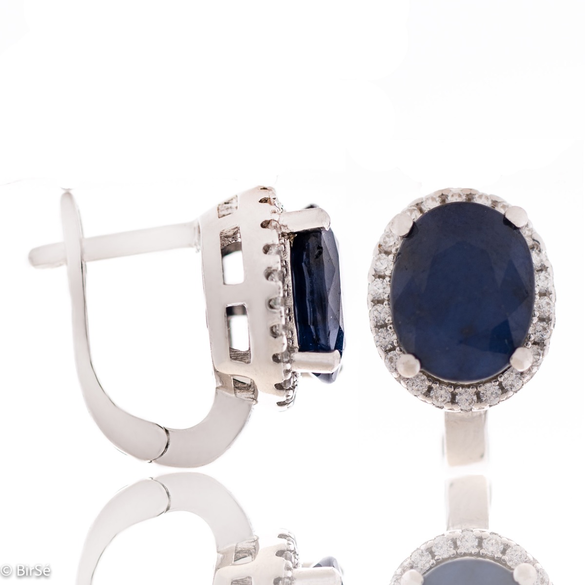 Unique women's earrings with English fastening and a spectacular combination of natural sapphire with sparkling zircons and captivating workmanship entirely from rhodium-plated silver. In an elegant set with a ring and necklace of the same model.