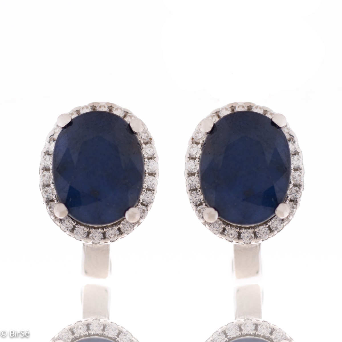 Unique women's earrings with English fastening and a spectacular combination of natural sapphire with sparkling zircons and captivating workmanship entirely from rhodium-plated silver. In an elegant set with a ring and necklace of the same model.