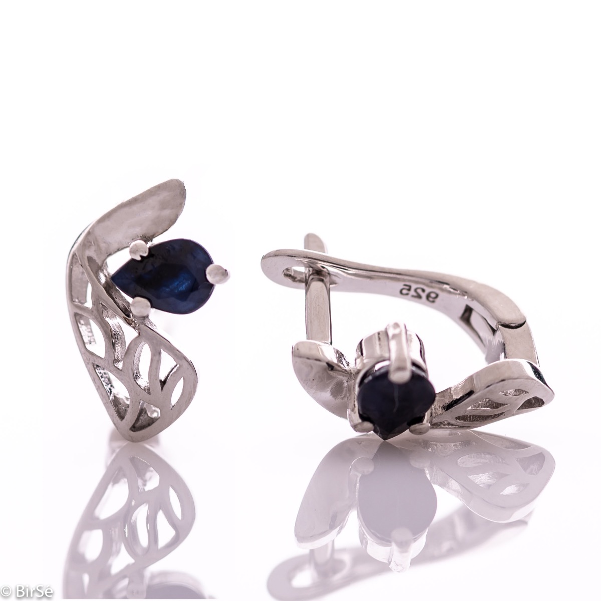 Delicate and spectacular ladies' earrings with English fastening and exquisite workmanship entirely of rhodium-plated silver combined with teardrop-shaped natural sapphire. They can be combined with a pendant and a ring from the same set.