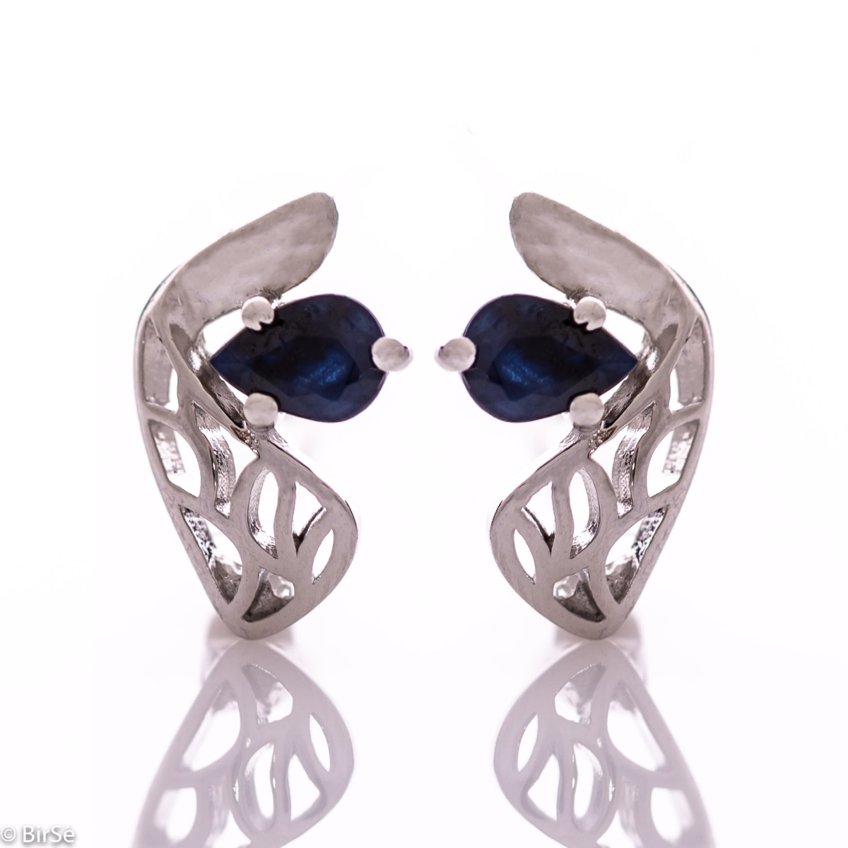 Delicate and spectacular ladies' earrings with English fastening and exquisite workmanship entirely of rhodium-plated silver combined with teardrop-shaped natural sapphire. They can be combined with a pendant and a ring from the same set.