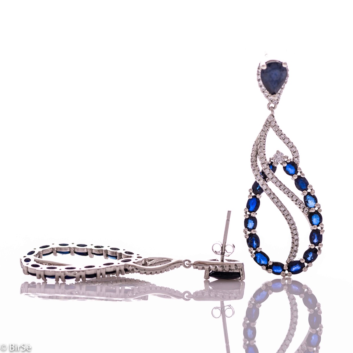 Women's dangling earrings with exceptional workmanship combining delicate rhodium silver with numerous and radiant natural sapphire and zircon stones.