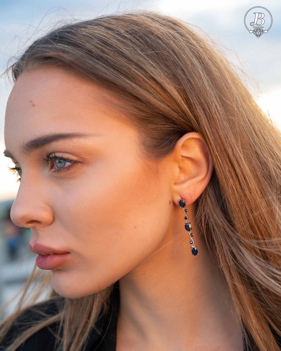 Extremely impressive dangling earrings with delicate workmanship combining numerous natural sapphire stones with shiny rhodium silver.