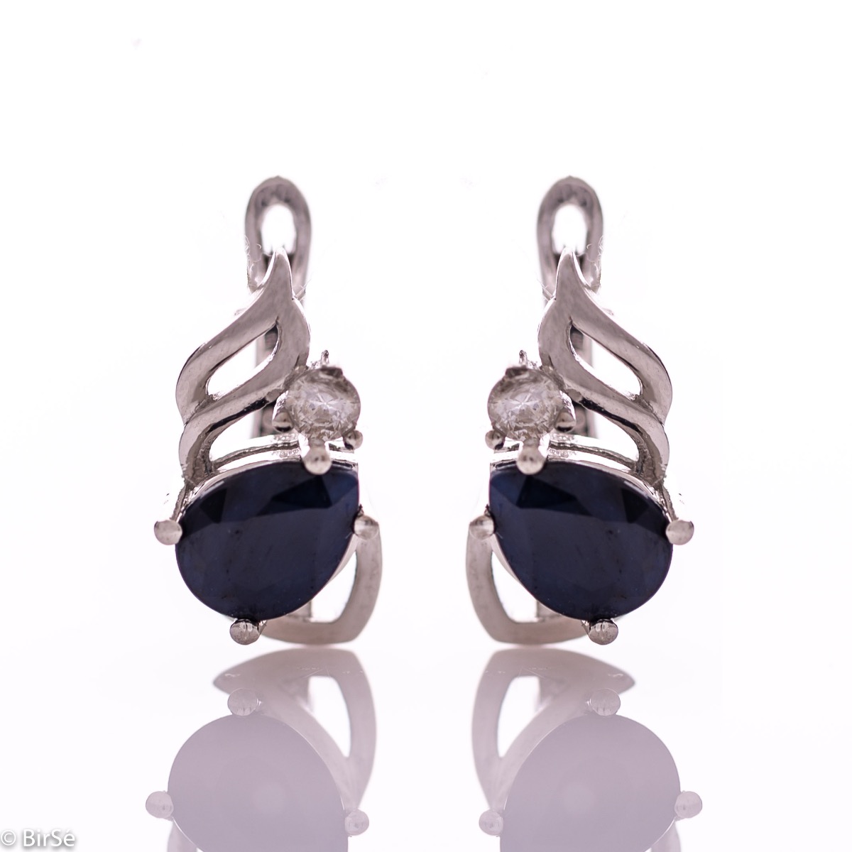 Radiant women's earrings with English clasp and a delicate combination of beautiful rhodium silver with a charming natural sapphire stone, in an exquisite teardrop shape, complemented by the sparkle of zircon.