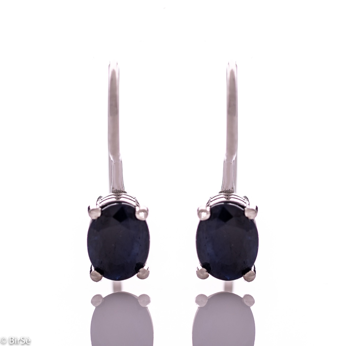 Delicate women's earrings with a clean and precise design combining shiny rhodium silver with radiant natural sapphire.