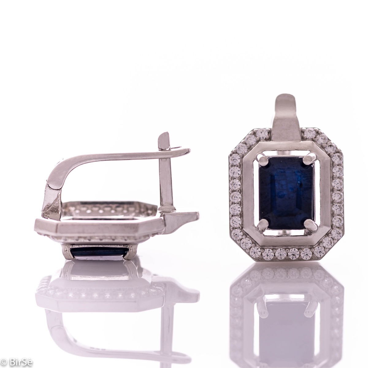 Elegant women's earrings with English clasp and precision craftsmanship entirely of rhodium-plated silver, combined with radiant natural sapphire and sparkling zircons. They can be combined with a ring and pendant of the same model.