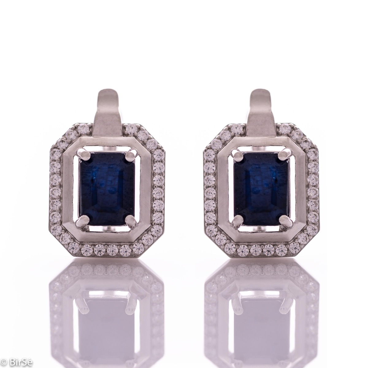 Elegant women's earrings with English clasp and precision craftsmanship entirely of rhodium-plated silver, combined with radiant natural sapphire and sparkling zircons. They can be combined with a ring and pendant of the same model.