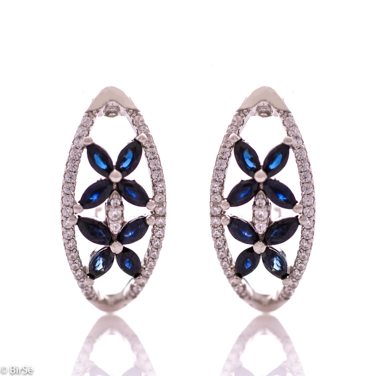 Spectacular women's earrings with exquisite workmanship entirely of rhodium-plated silver, combined with delicate flowers of natural sapphire and sparkling zircons. They can be combined with a ring and pendant of the same model.