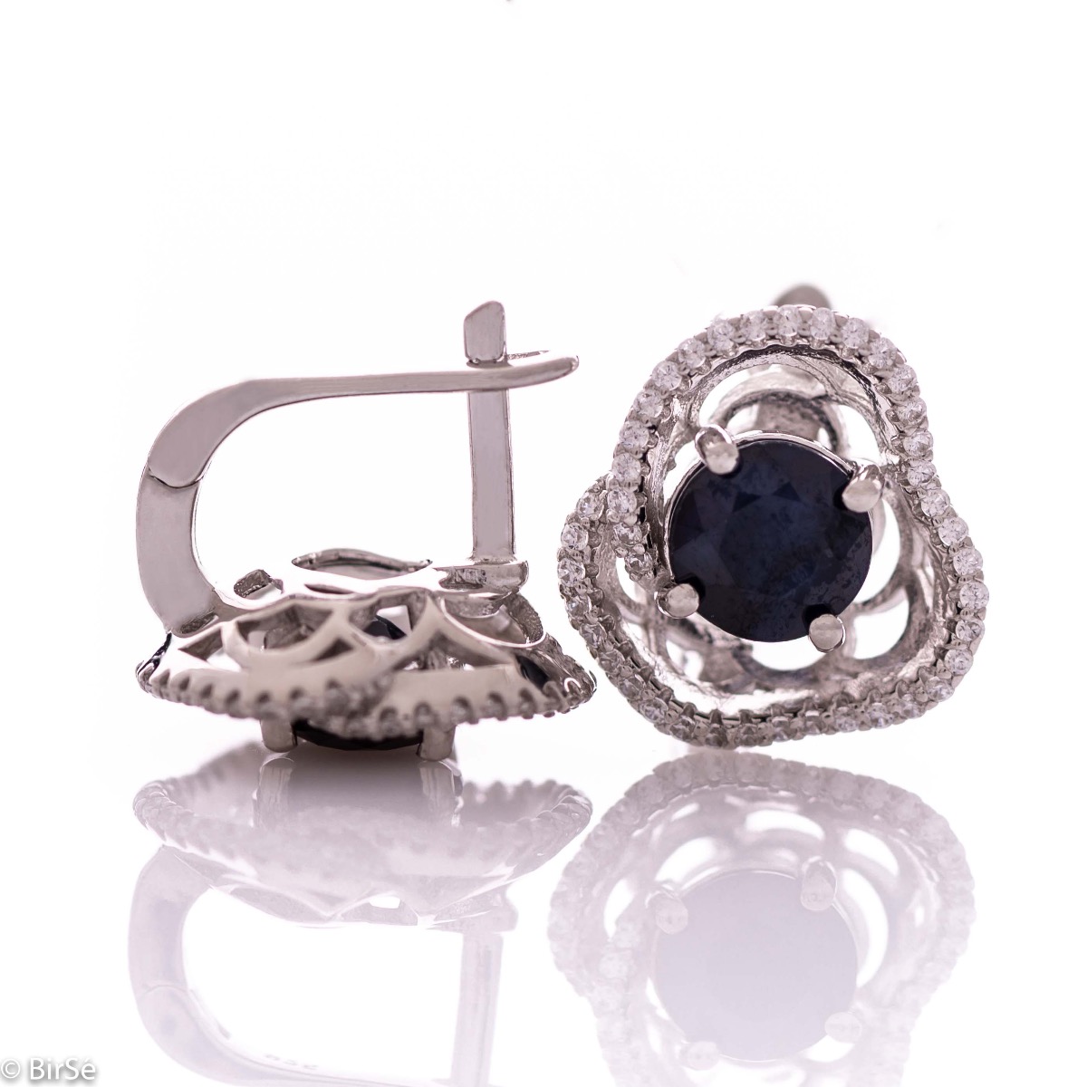 Elegant women's earrings with English clasp and exquisite workmanship entirely of rhodium-plated silver complemented by the glow of natural sapphire and sparkling zircons. They can be combined with a ring and pendant of the same model.