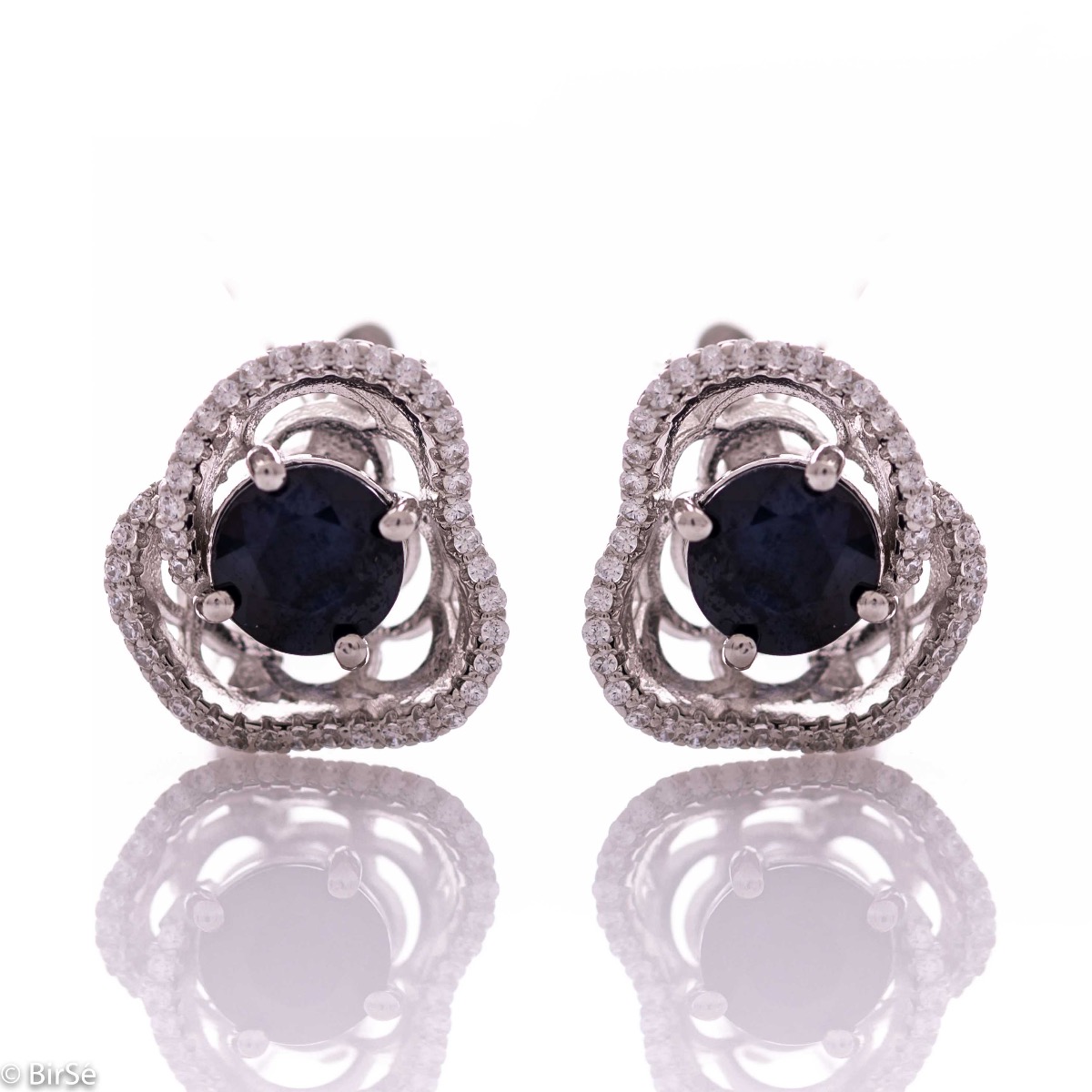 Elegant women's earrings with English clasp and exquisite workmanship entirely of rhodium-plated silver complemented by the glow of natural sapphire and sparkling zircons. They can be combined with a ring and pendant of the same model.