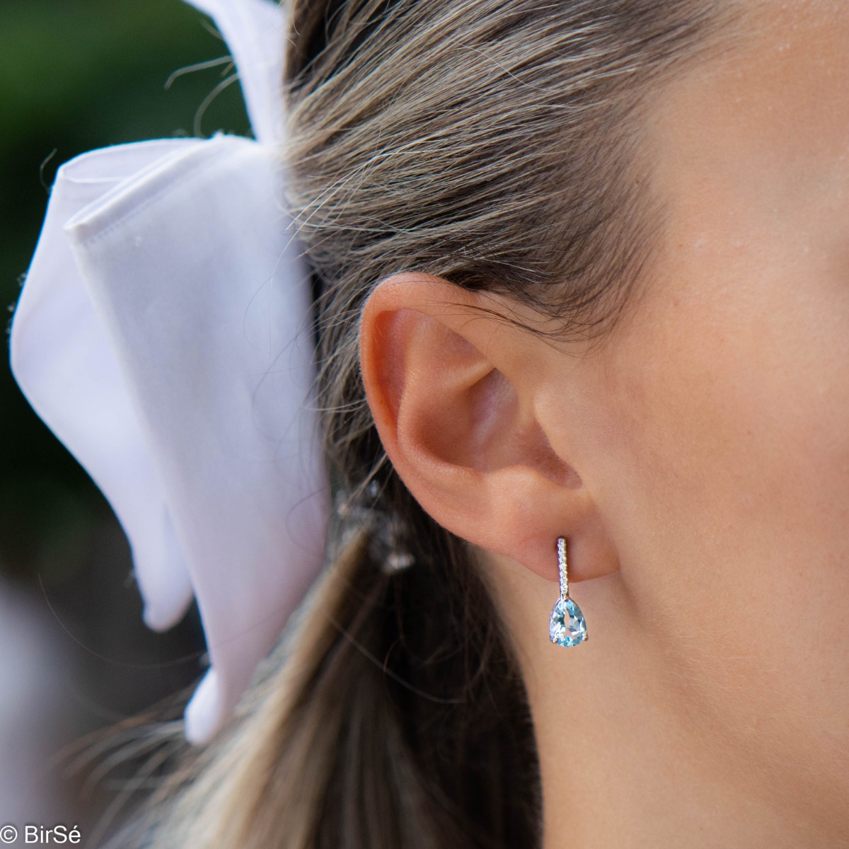 The beauty of azure blue in lovely sterling silver earrings with natural blue topaz and enchanting zircons.