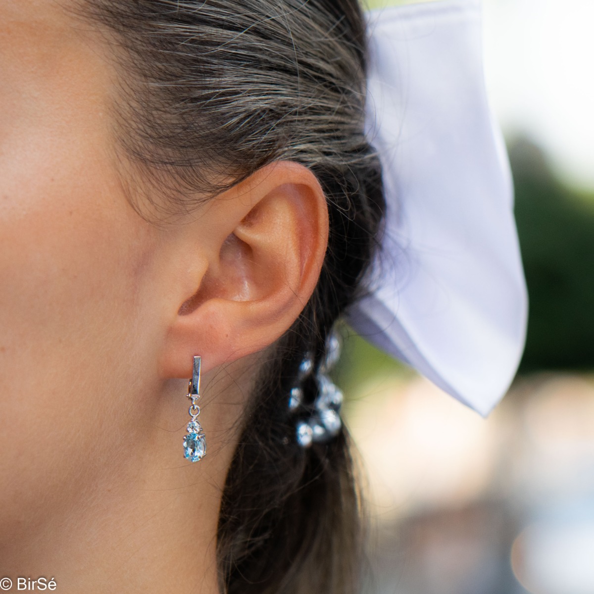 Elegant rhodium silver dangle earrings for every style - these are our earrings with a captivatingly delicate blue topaz. Elegance yourself or a loved one with the complete set, which includes a ring and pendant with the same lovely design.