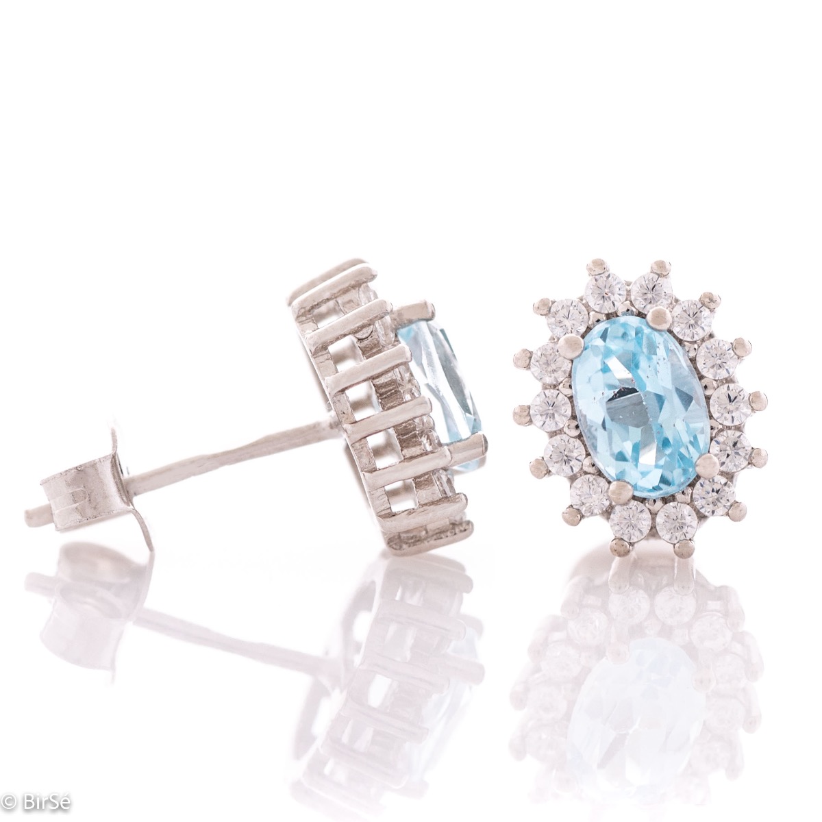 A gentle glow of a natural blue topaz stone surrounded by sparkling zircons - our new women's stud earrings, finely crafted entirely in rhodium silver.