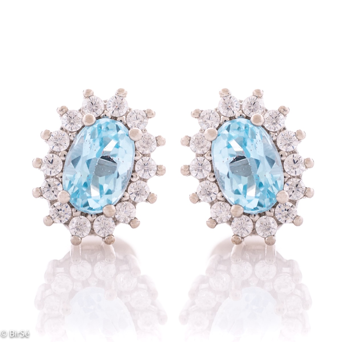 A gentle glow of a natural blue topaz stone surrounded by sparkling zircons - our new women's stud earrings, finely crafted entirely in rhodium silver.